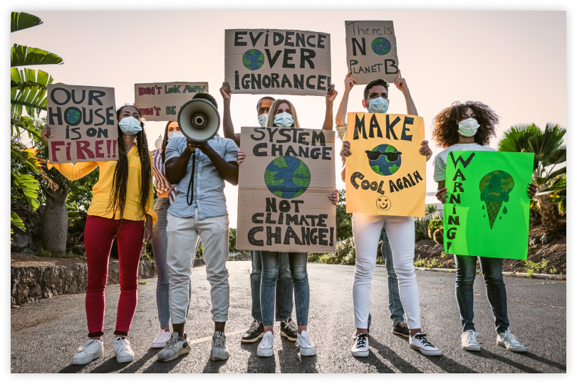 Group of protestors hold up climate justice signs