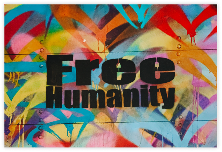 Colorful mural with hearts and "free humanity" in black text